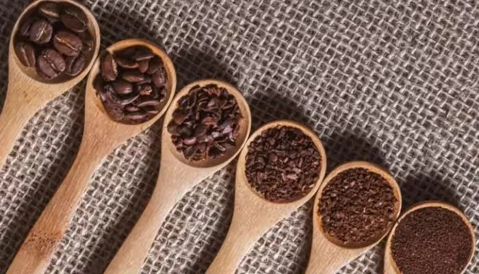 Kaffy coffee-ground coasters laid out in a row on woven fabric