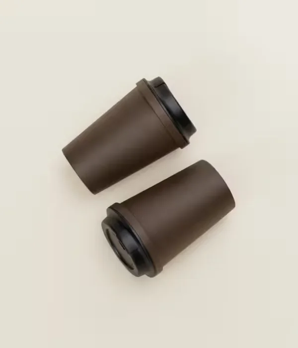 Two Kaffy coffee-ground tumblers on a cream background